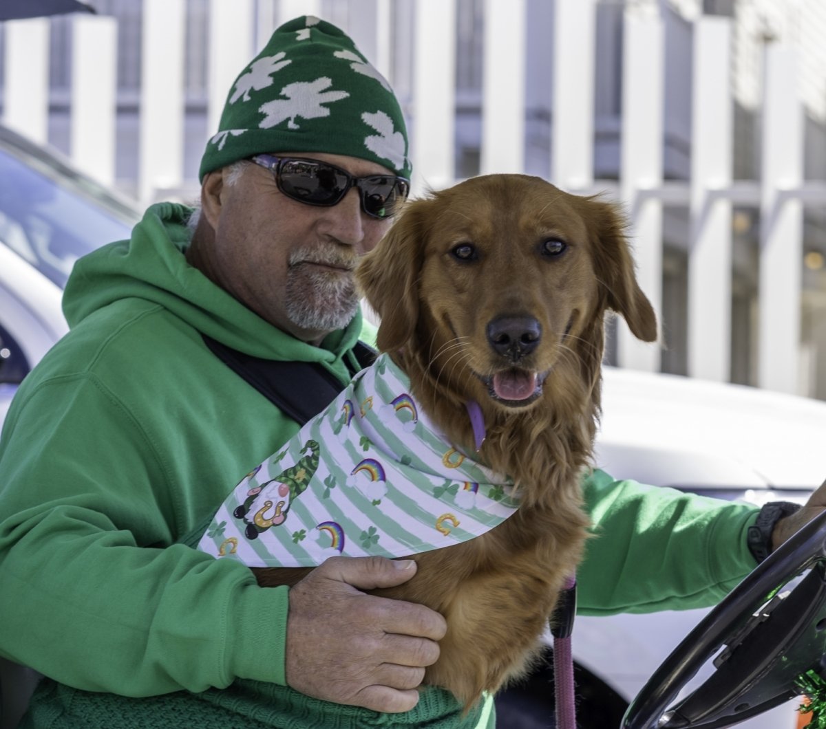Man & dog dressed in green
